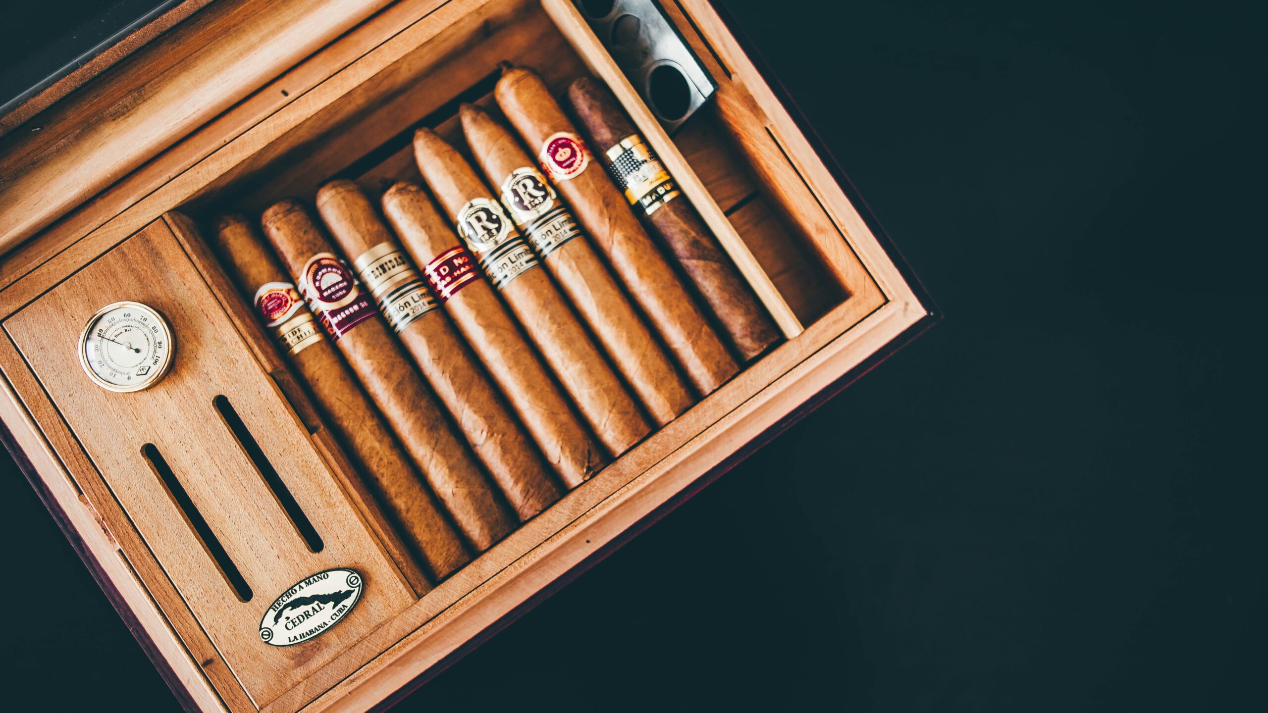 About Close-up of premium Cuban cigars in a wooden humidor box, showcasing luxury and craftsmanship.